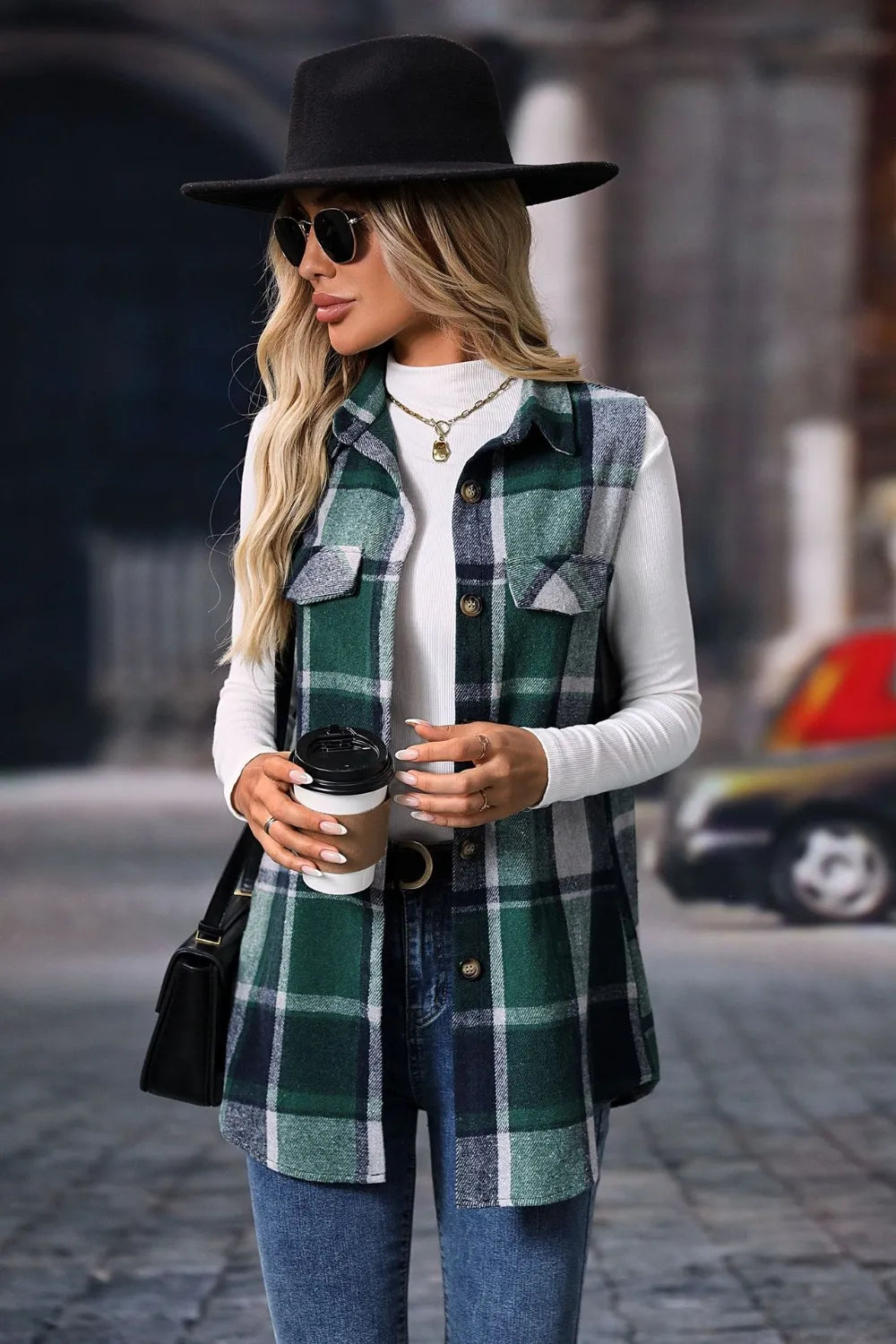 Dark green plaid vest styled with a black fedora and a coffee cup