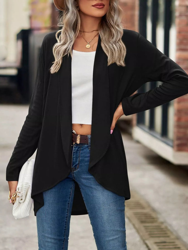 Black high low hem cardigan with hand on hip, worn open over white top