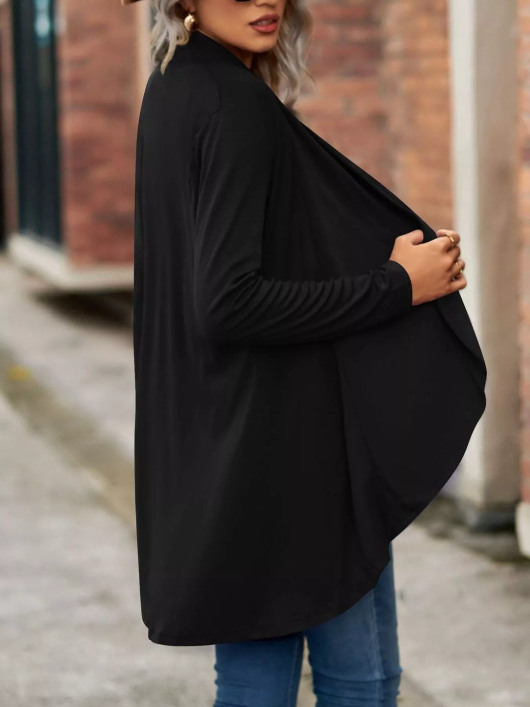 Side view of the black waterfall cardigan with draped front