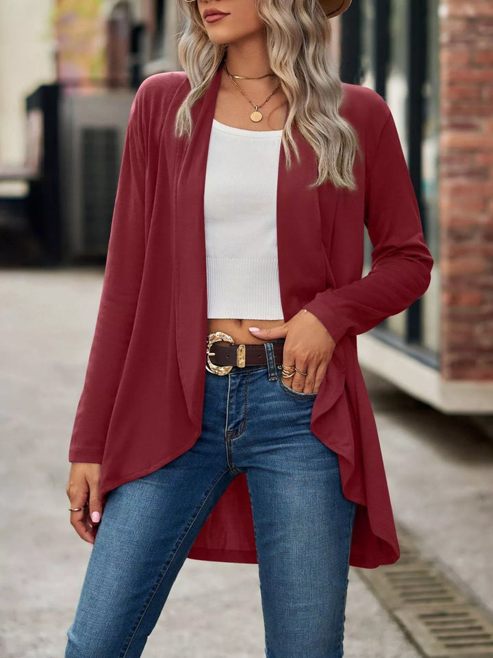 Burgundy high low hem cardigan worn open with belted jeans