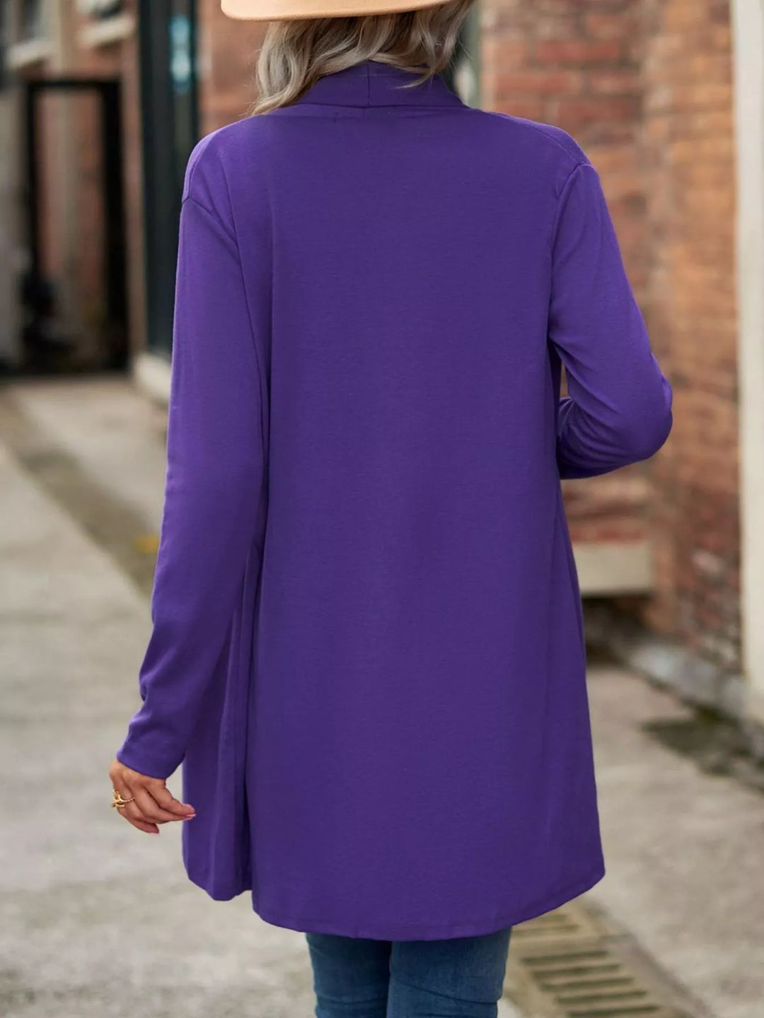 Back view of the purple long cardigan with rounded hem