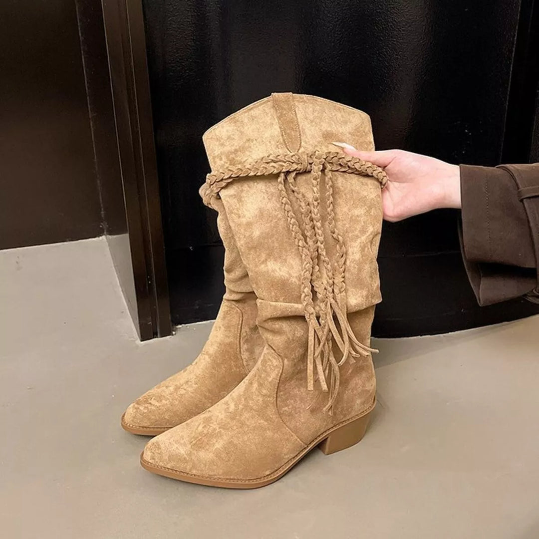 Side angle of the camel slouch boots with fringe held open at the shaft