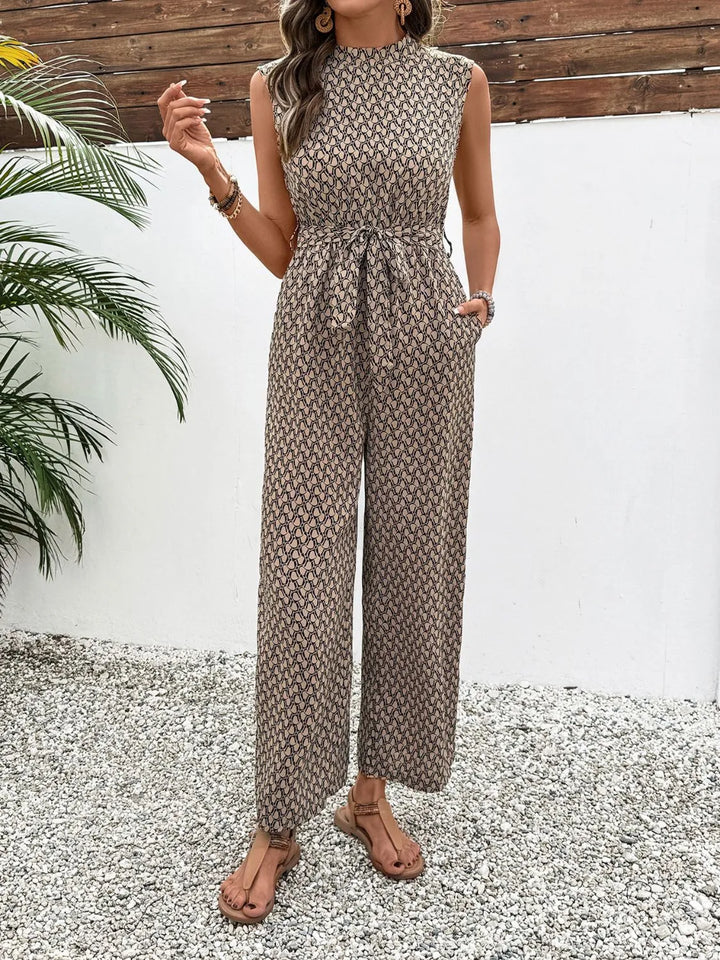 Women's wide leg jumpsuit in taupe print, sleeveless mock neck with tie belt, front view