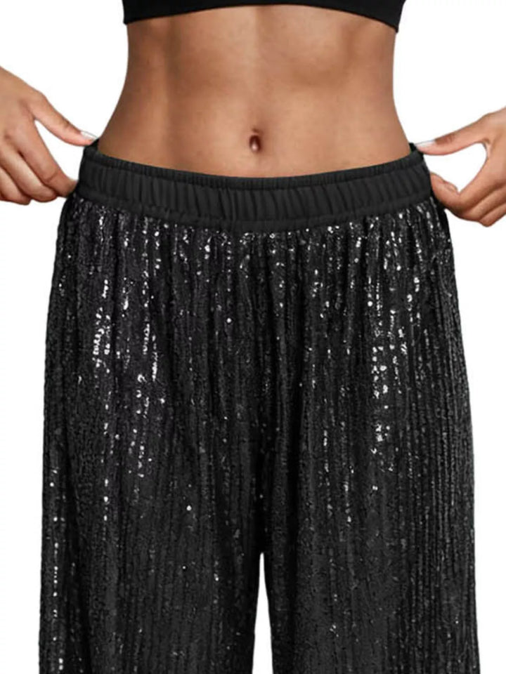 Close-up of the black sequin wide leg pants elastic waistband