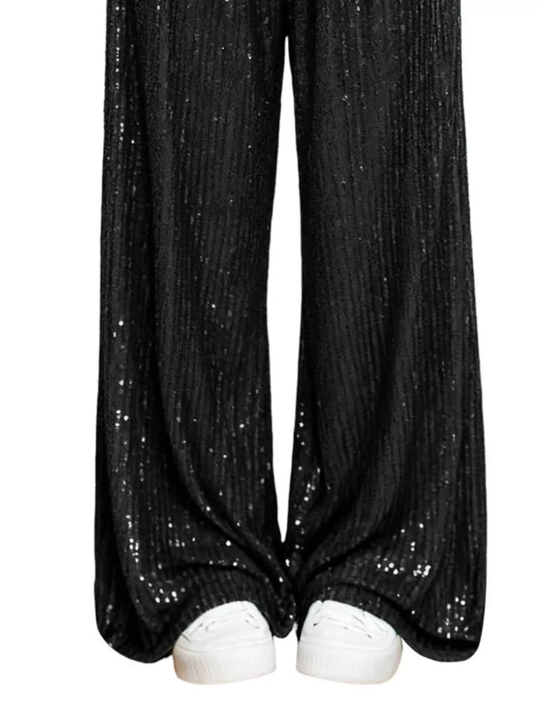Black sequin wide leg pants hem over white sneakers