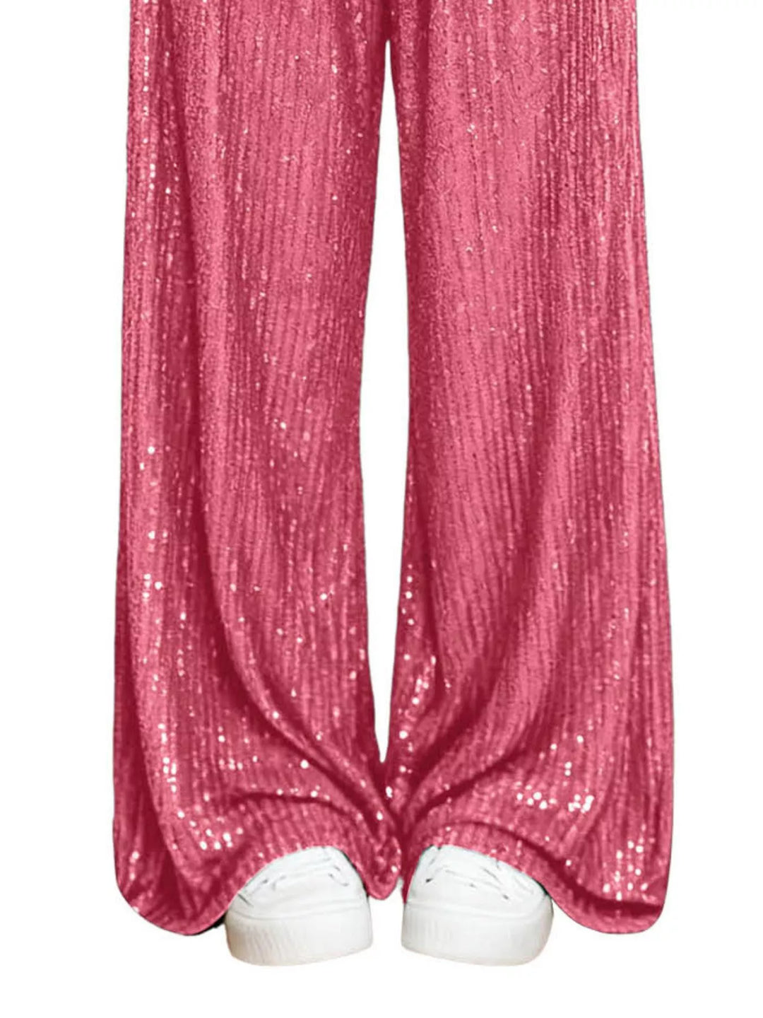 Hot pink sequin wide leg pants hem over white sneakers