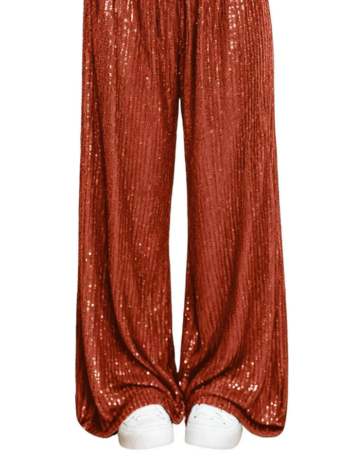 Rust sequin wide leg pants hem and white sneakers