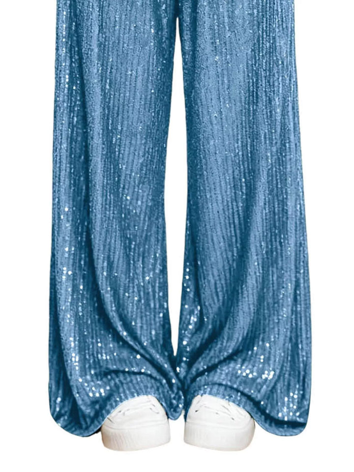 Sky blue sequin wide leg pants hem over white sneakers