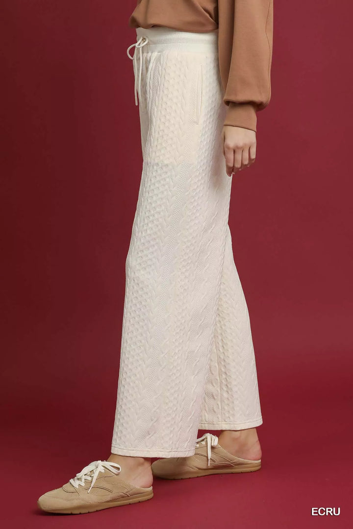 Side view of the ivory cable knit wide leg pants with drawstring waist