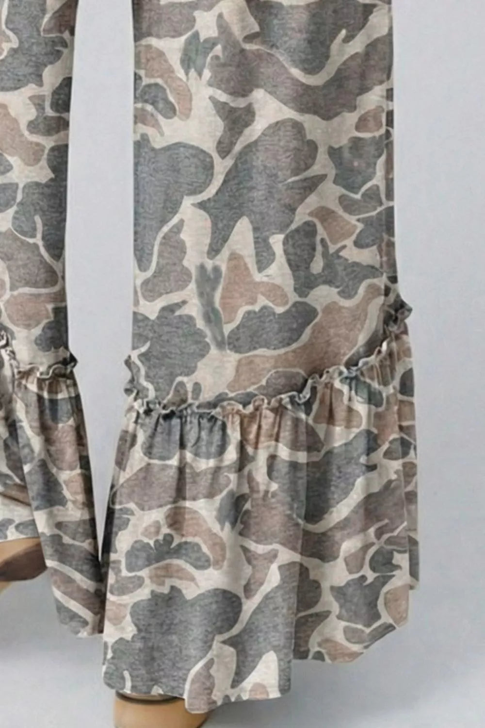 Close-up of the camo print ruffled hem on wide leg pants