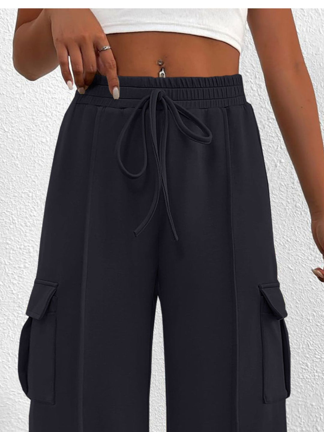 Close-up of the women's charcoal cargo pockets and drawstring waist