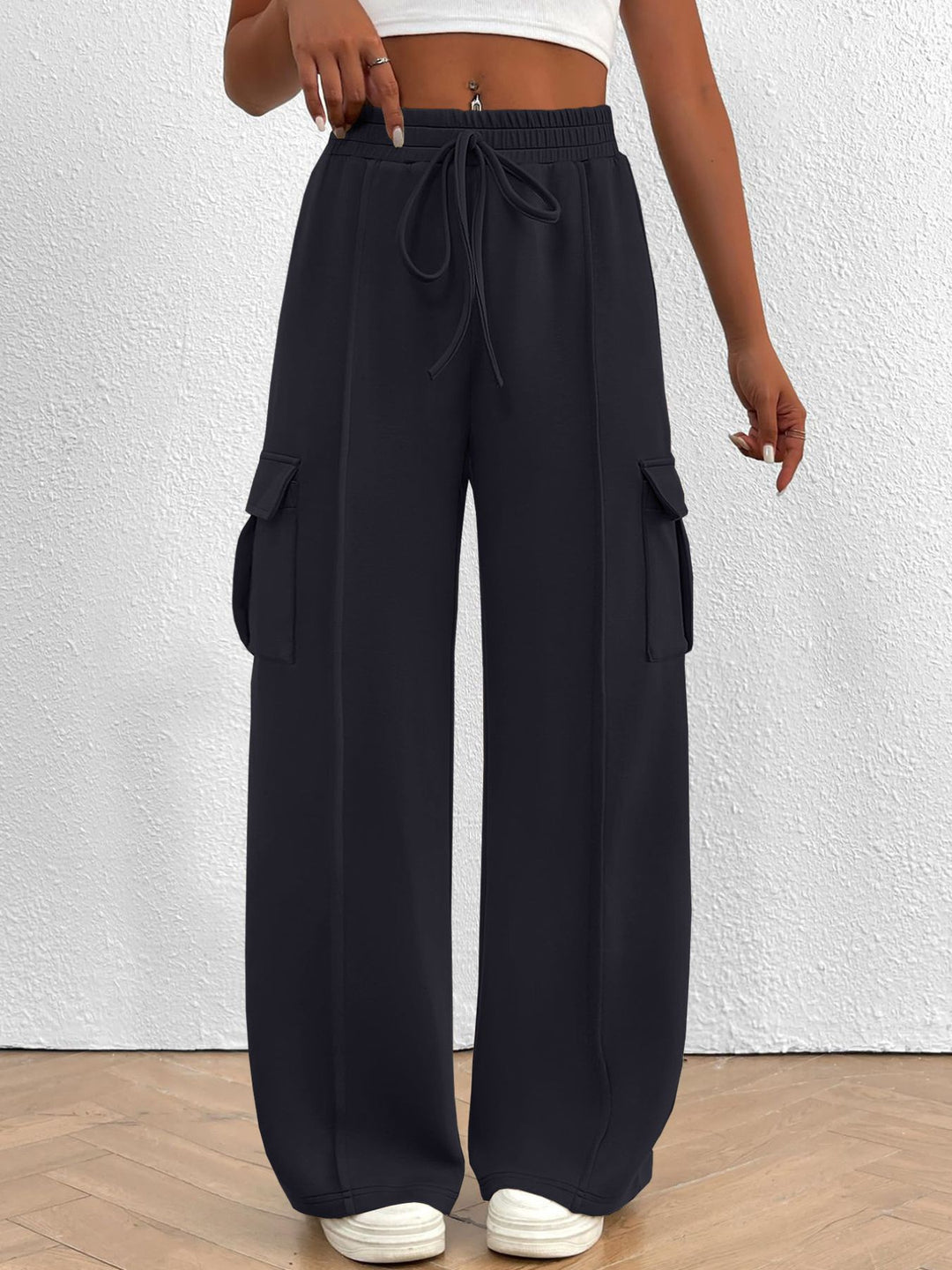 Charcoal wide leg cargo pants with high waist and drawstring, front view