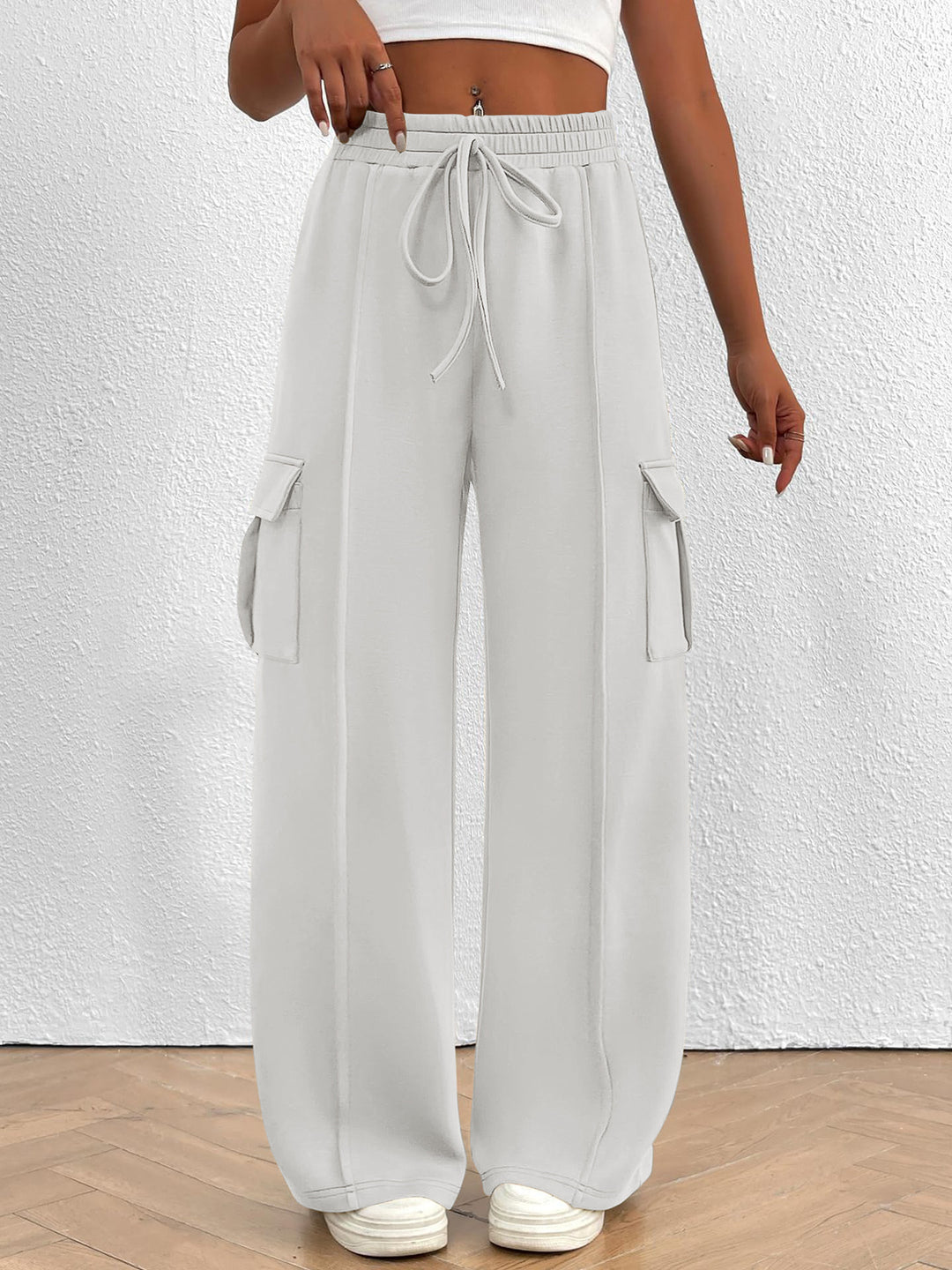 Women's white wide leg cargo pants with high waist and drawstring, front view