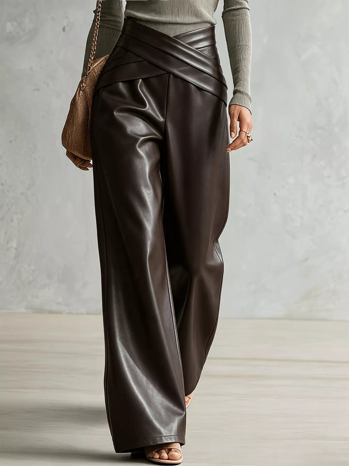 Brown high shine wide leg pants captured mid-step from the side