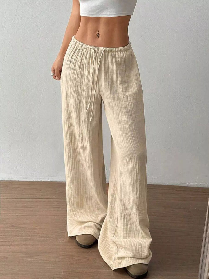 Side view of the beige drawstring wide leg pants