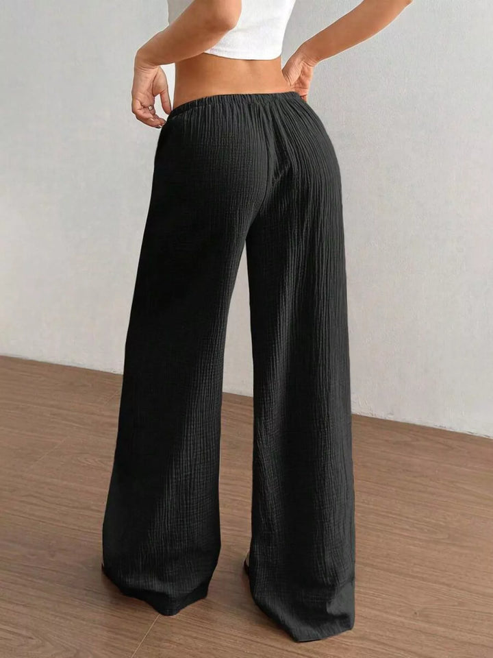 Back view of the black wide leg pants with elastic waist