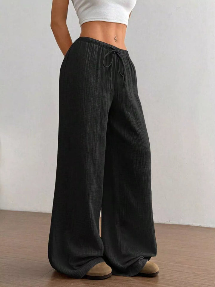 Full length black wide leg pants with drawstring tied at the front