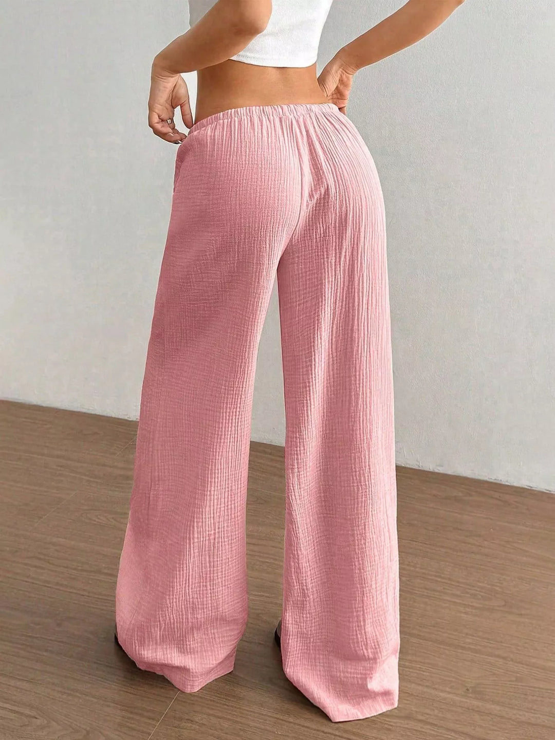 Back view of the pink crinkled wide leg pants