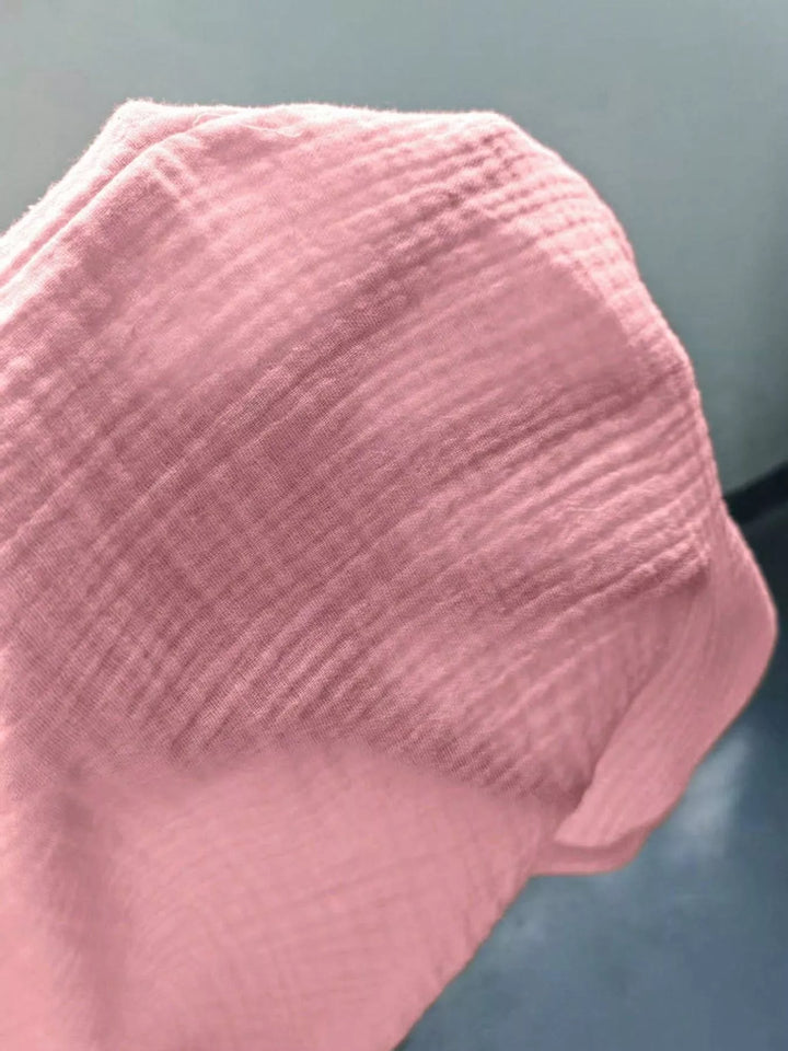 Close-up of the pink crinkled fabric texture folded over