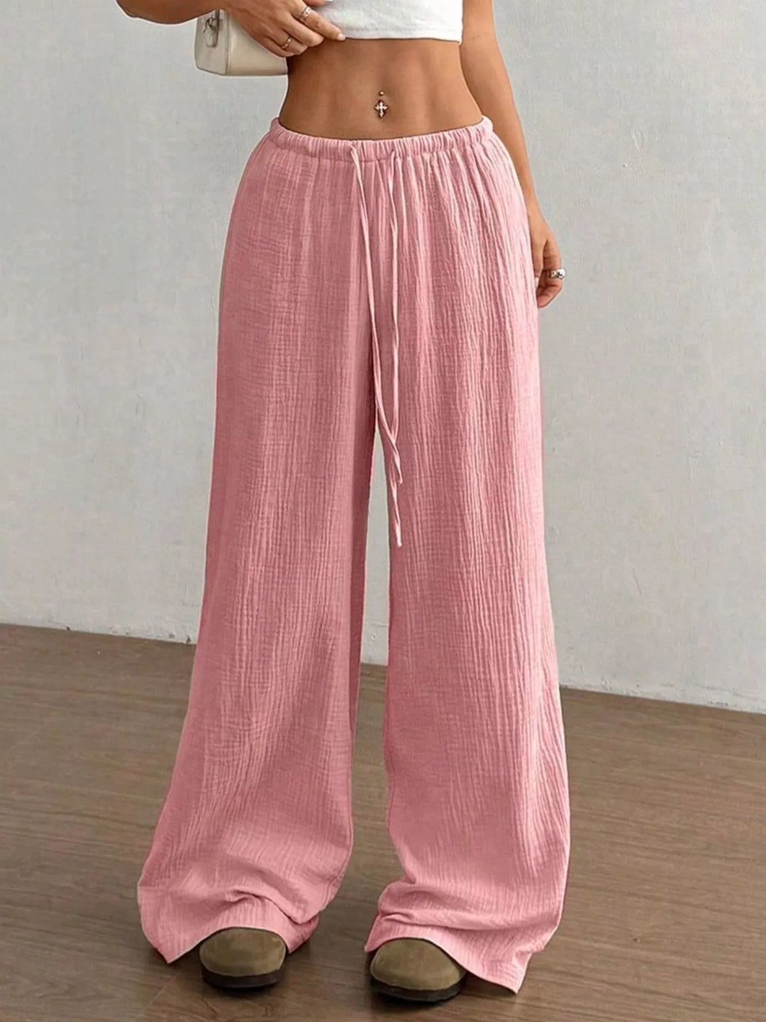 Full length pink wide leg pants falling over the shoes