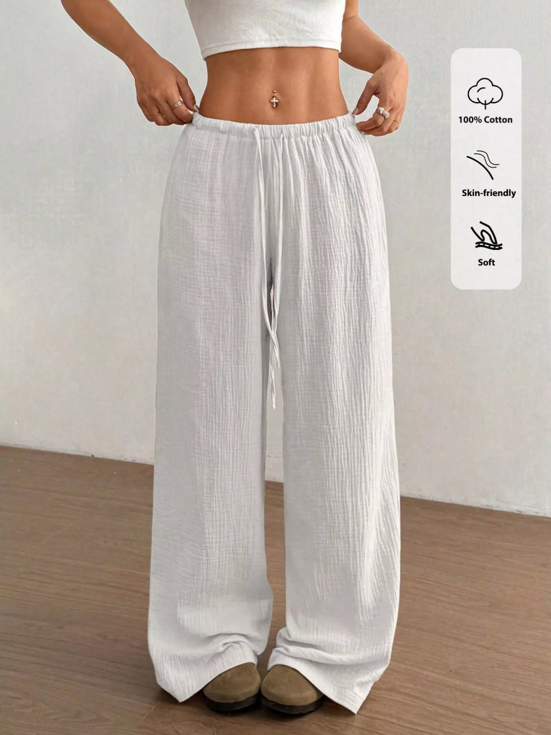 Women's wide leg pants in white, drawstring elastic waist crinkled, front view with fabric tags