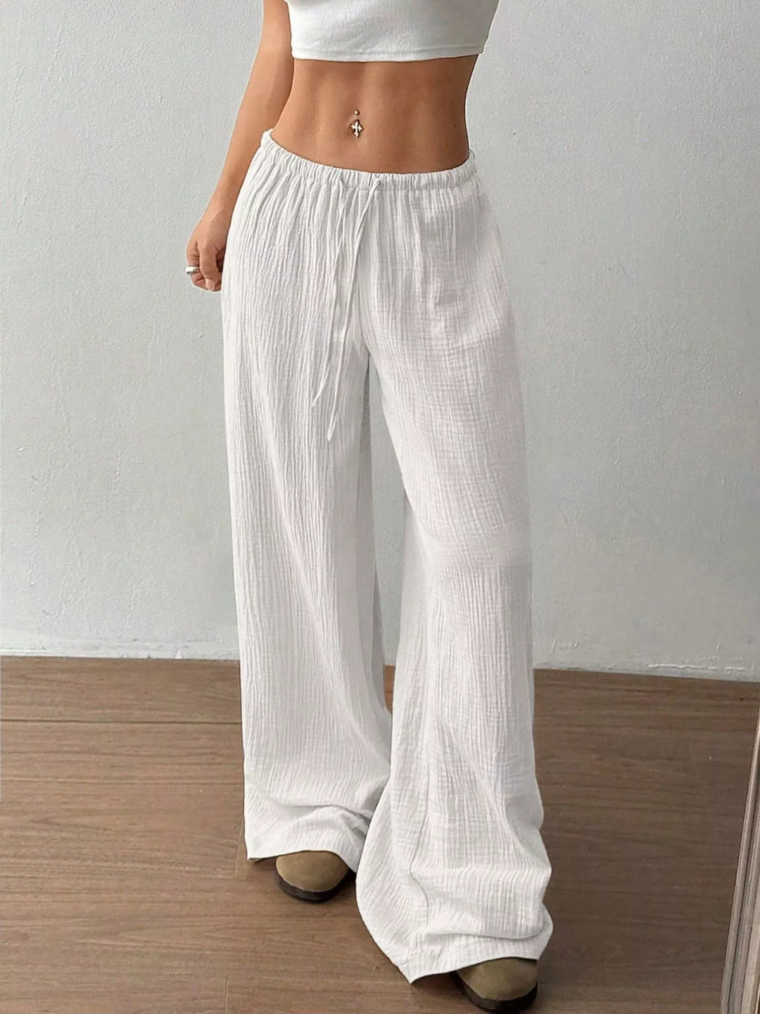 Side angle of the white wide leg pants showing the drawstring tie