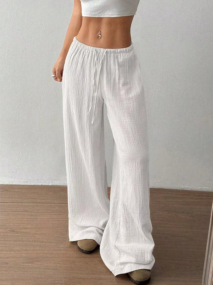 Side angle of the white wide leg pants showing the drawstring tie