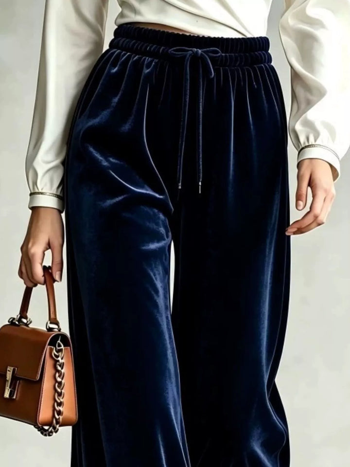 Close-up of the navy drawstring waist and wide soft pile legs