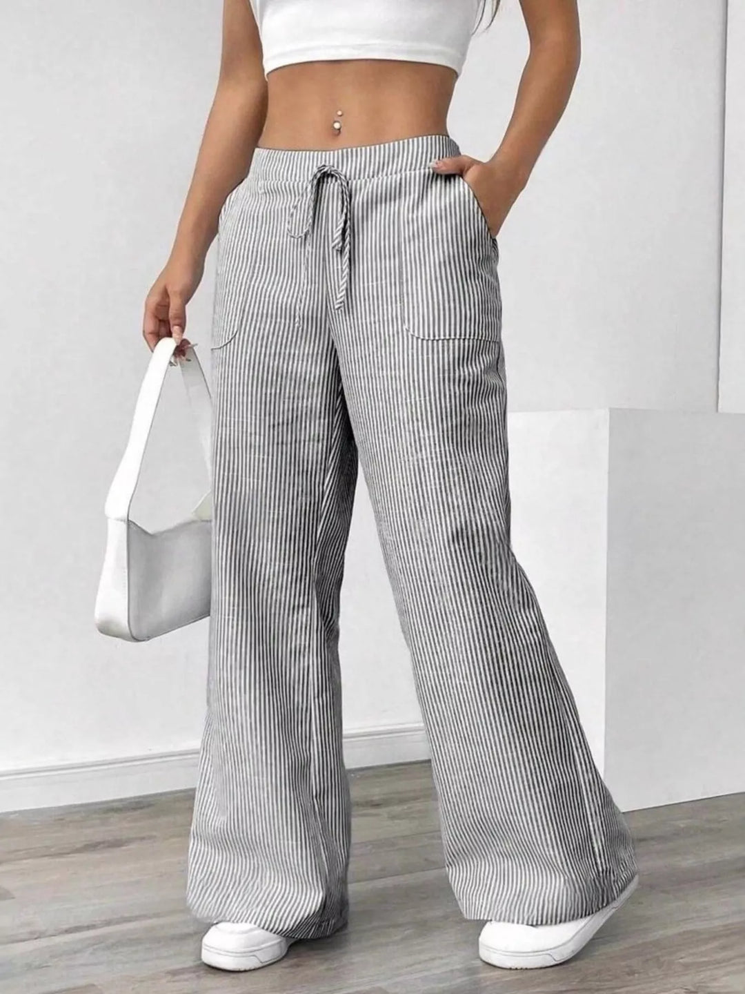 Women's wide leg pants in light gray, drawstring waist with fine stripe texture, front view