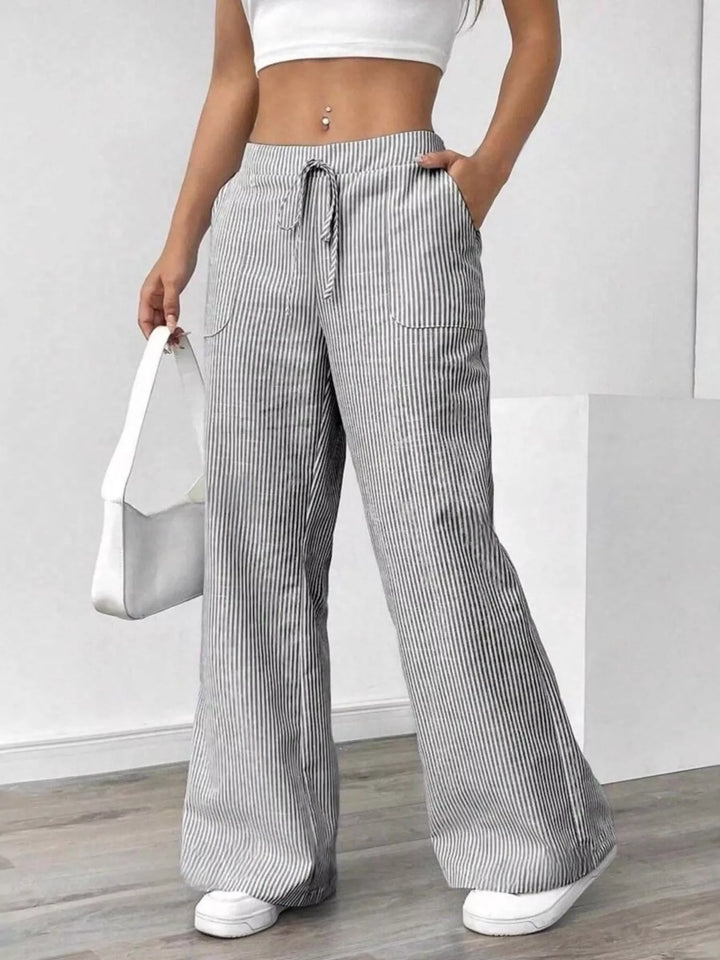 Women's wide leg pants in light gray, drawstring waist with fine stripe texture, front view