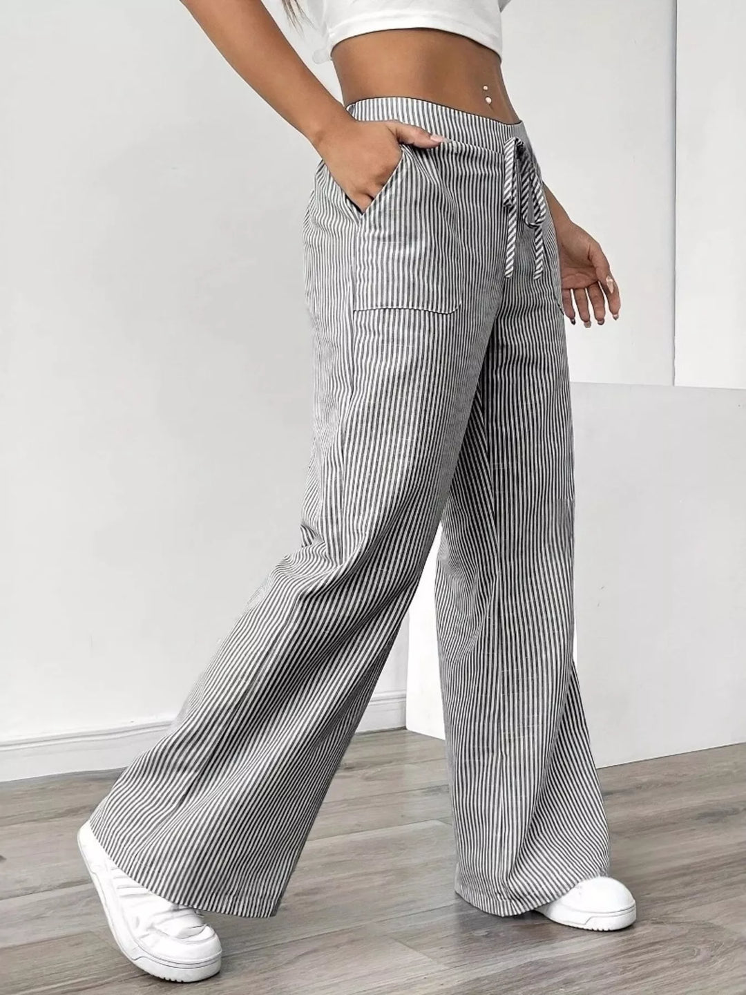 Light gray drawstring wide leg pants, angled side view with hand in pocket