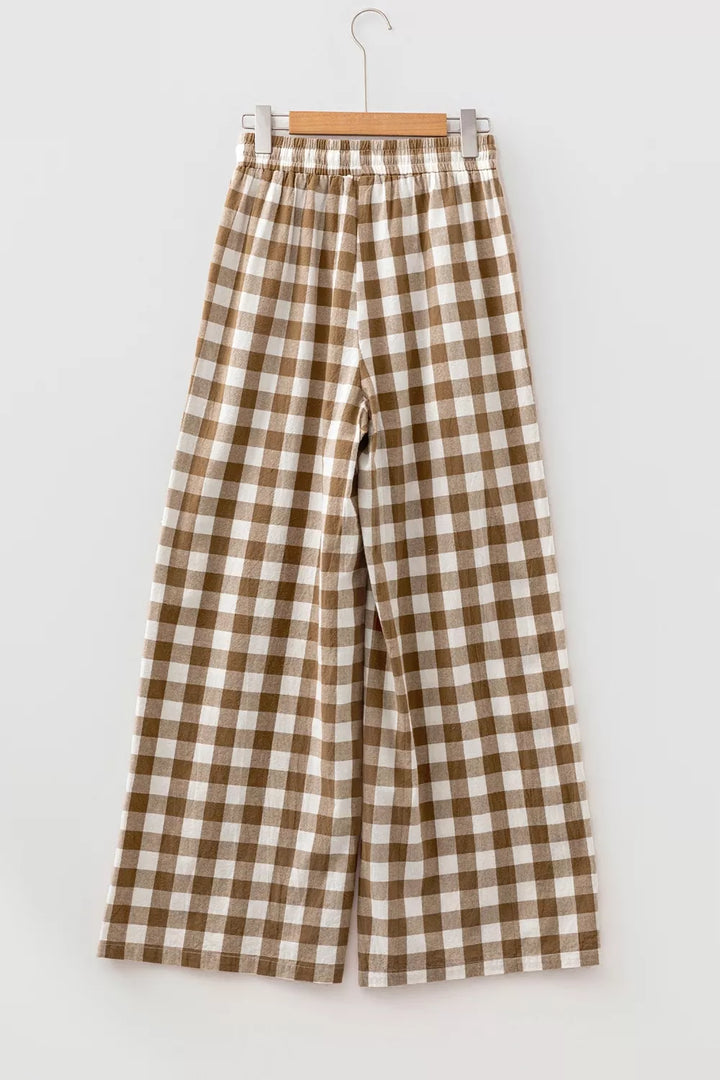 Back view of the brown gingham pants hanging on a hanger