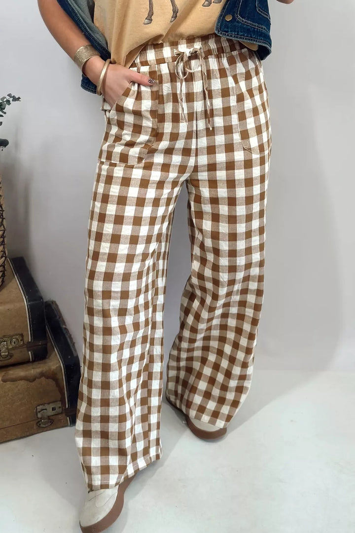 Brown gingham drawstring pants with patch pockets and a denim jacket, angled view