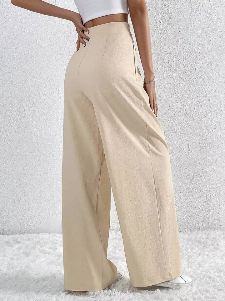 Back view of the beige high waist pleated wide leg pants