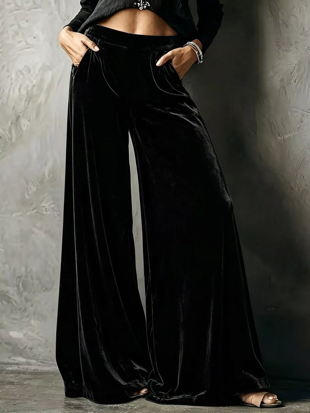 Black high waisted wide leg pants with a shiny velvet-look finish