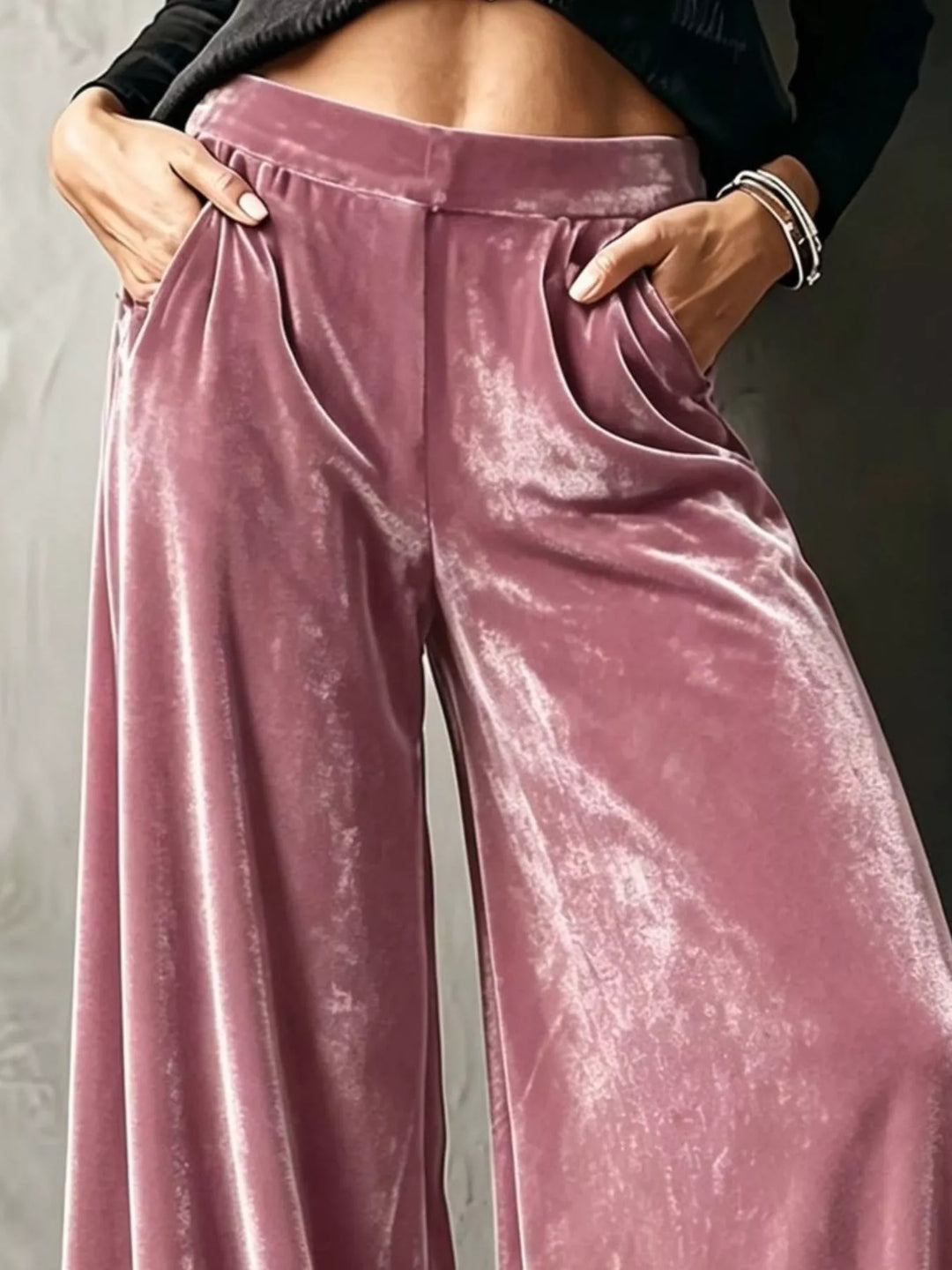 Close-up of dusty rose wide leg pants with side pockets and shiny drape
