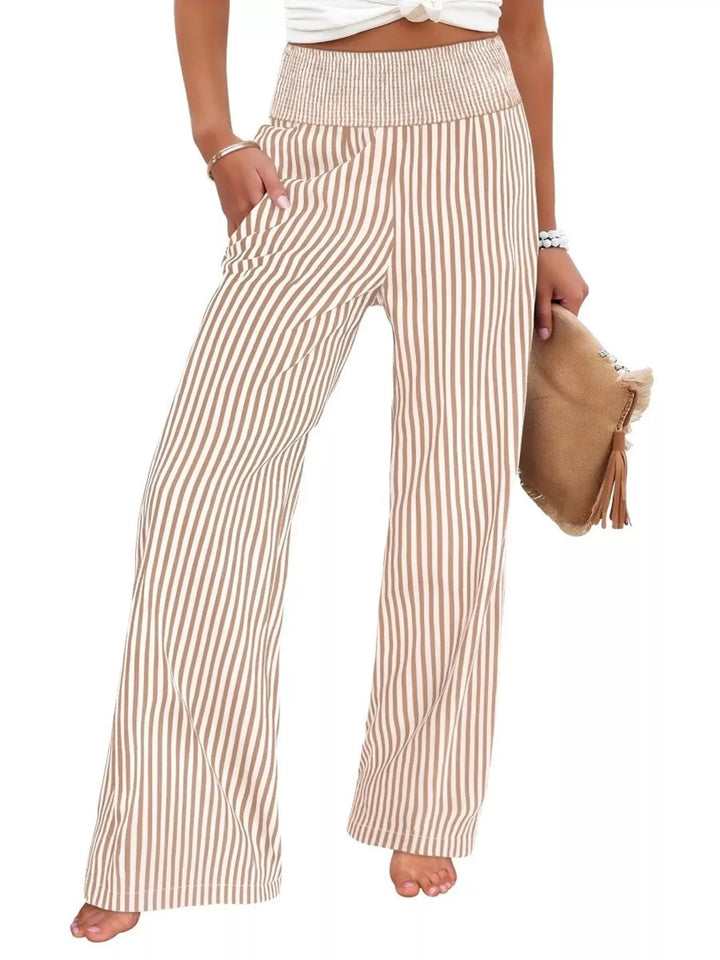 Beige high waisted striped wide leg pants, front view with a brown clutch