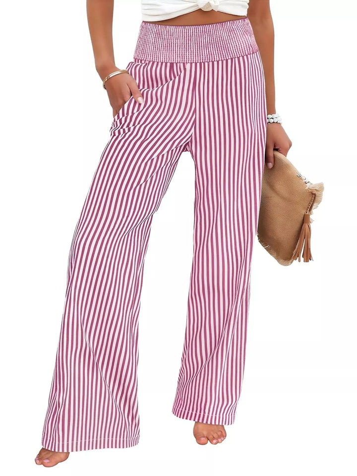 Berry pinstripe high waisted wide leg pants, front view holding a clutch