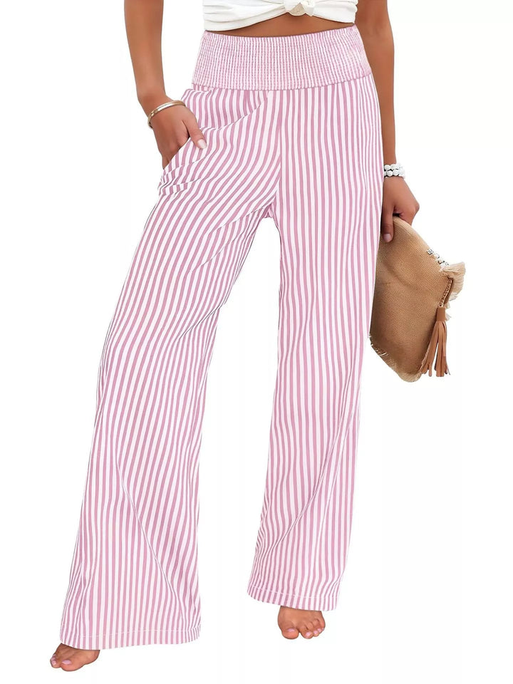 Pink pinstripe high waisted wide leg pants, front view with a woven clutch