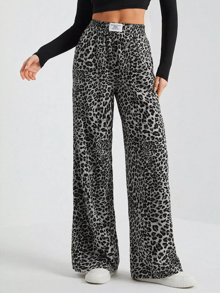 Gray leopard print wide leg pants with elastic waist and white sneakers
