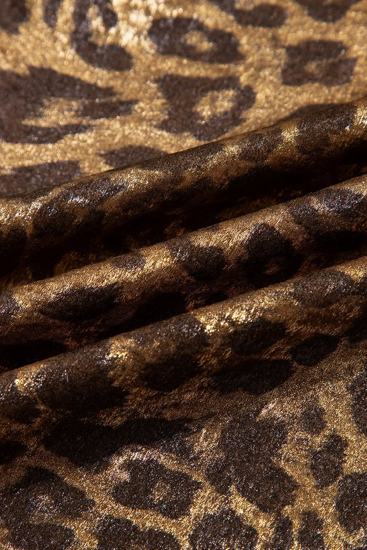 Close-up of the metallic leopard print fabric texture and gold sheen