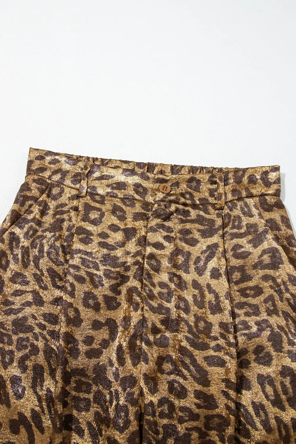 Close-up of the leopard print pants elastic waistband and pleats