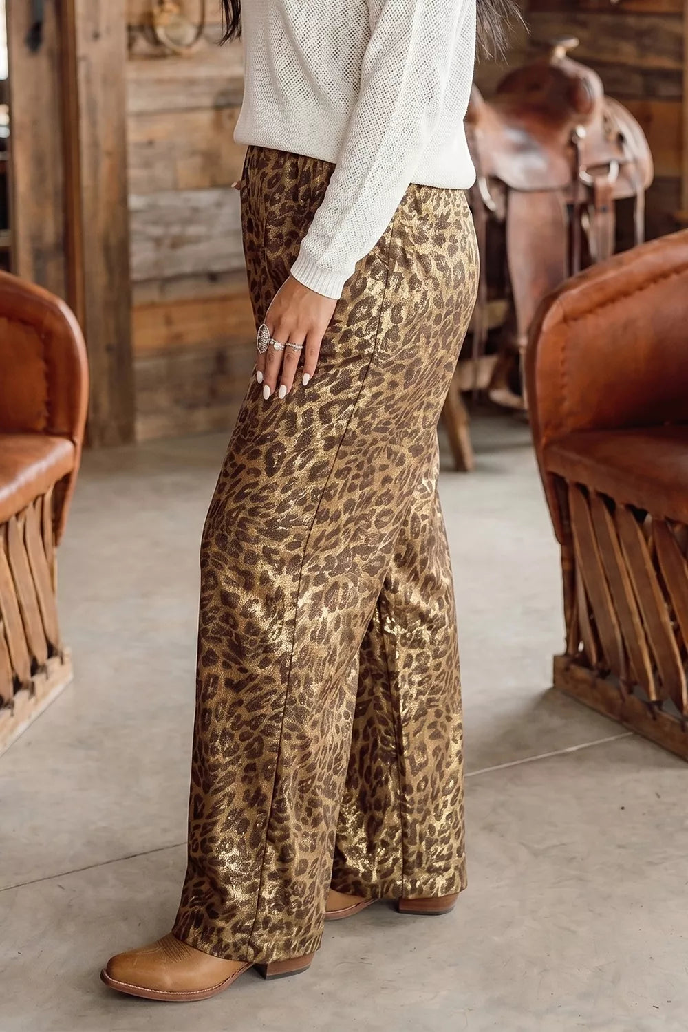 Leopard wide leg pants with elastic waist, angled side view in boots