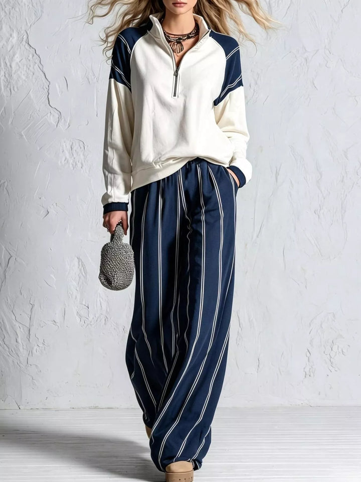 Navy striped wide leg pants with cream quarter zip pullover, front view