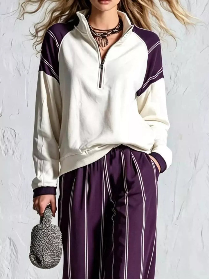Close-up of the plum raglan sleeve quarter zip pullover and striped pants