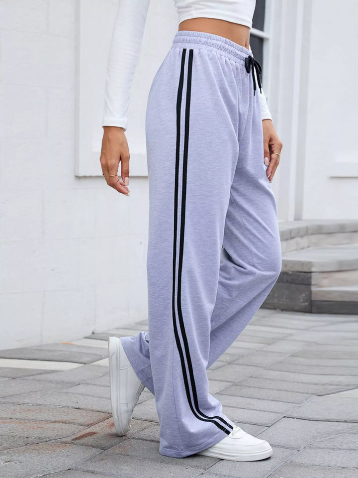Lavender side striped wide leg pants, side view while walking