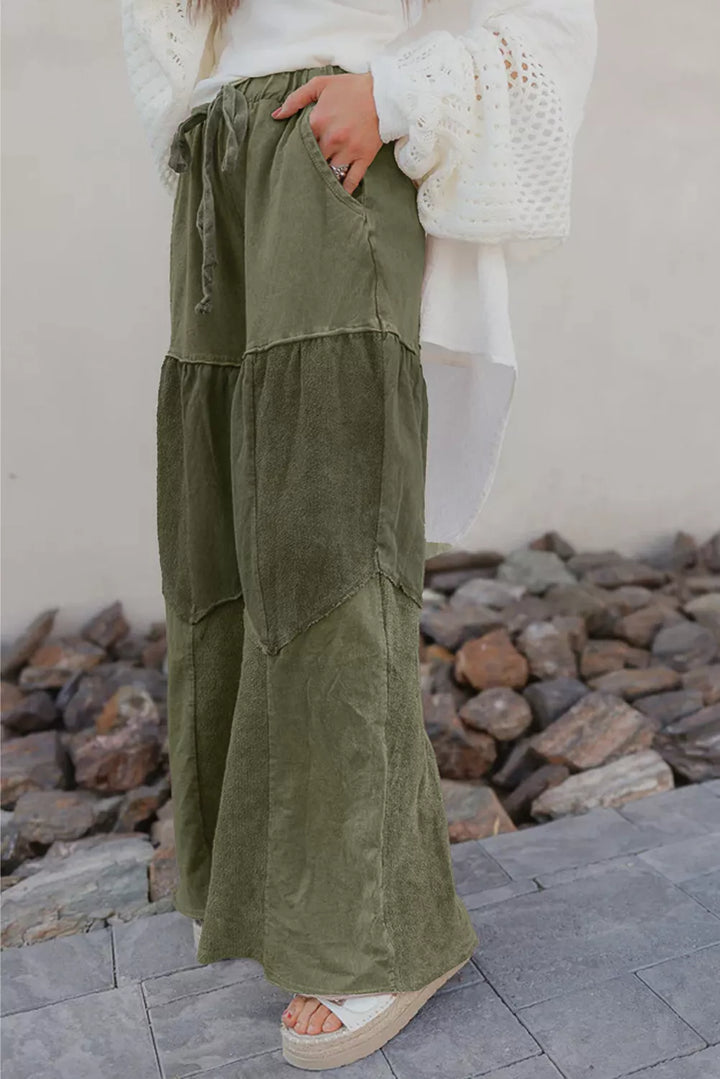 Full length view of the olive green tiered wide leg pants with platform sandals