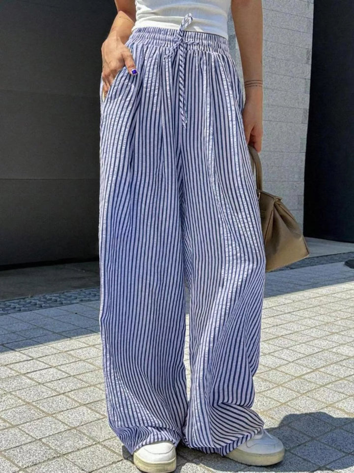 Blue vertical pinstripe wide leg pants with drawstring waist, front view