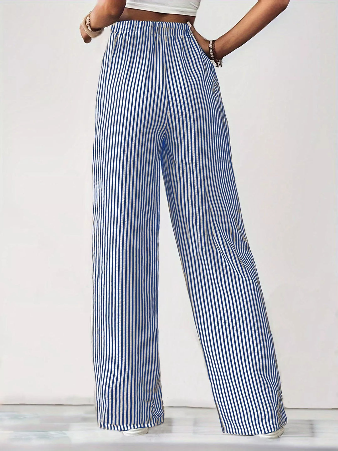 Blue lightweight pinstripe wide leg pants on a plain backdrop