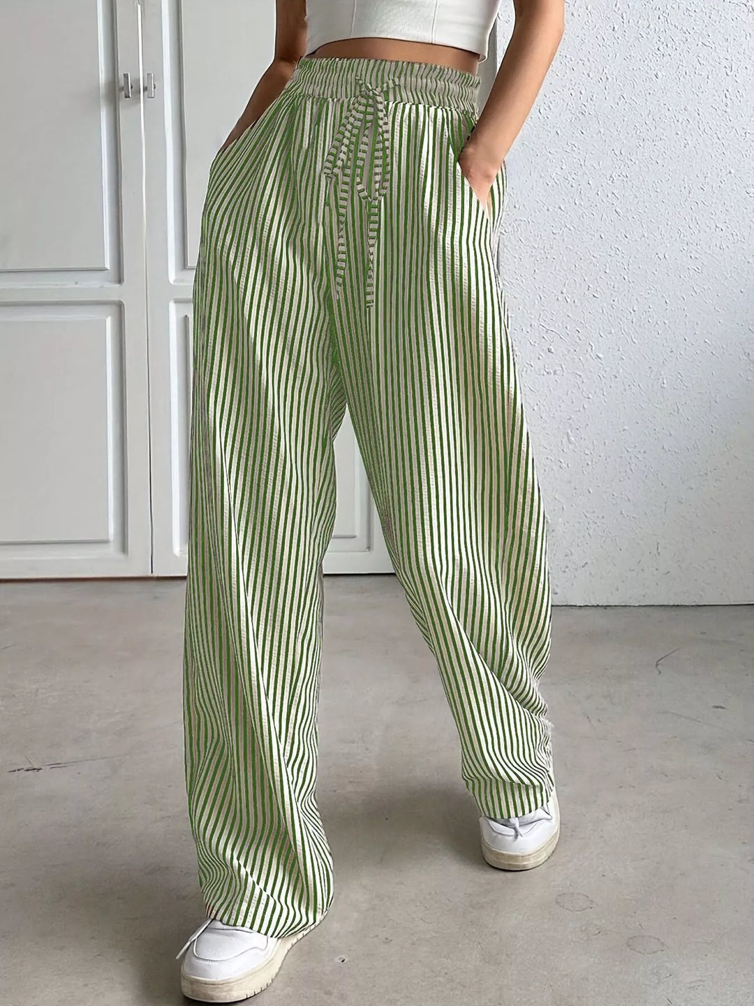 Light green pinstripe wide leg pants with drawstring, indoor front view